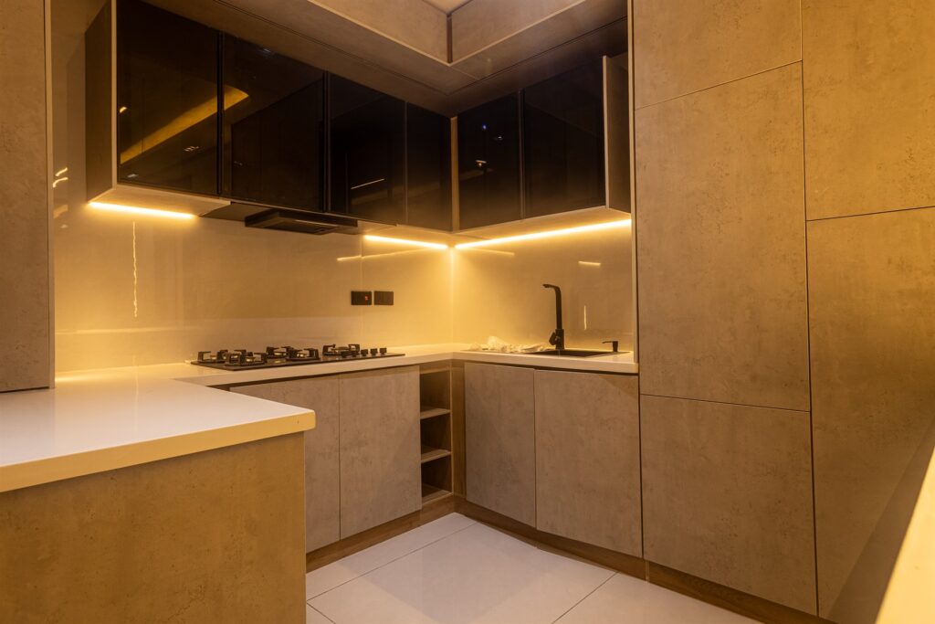 Brum Height 9: Fitted kitchen with wood-tone cabinets and a gas hob